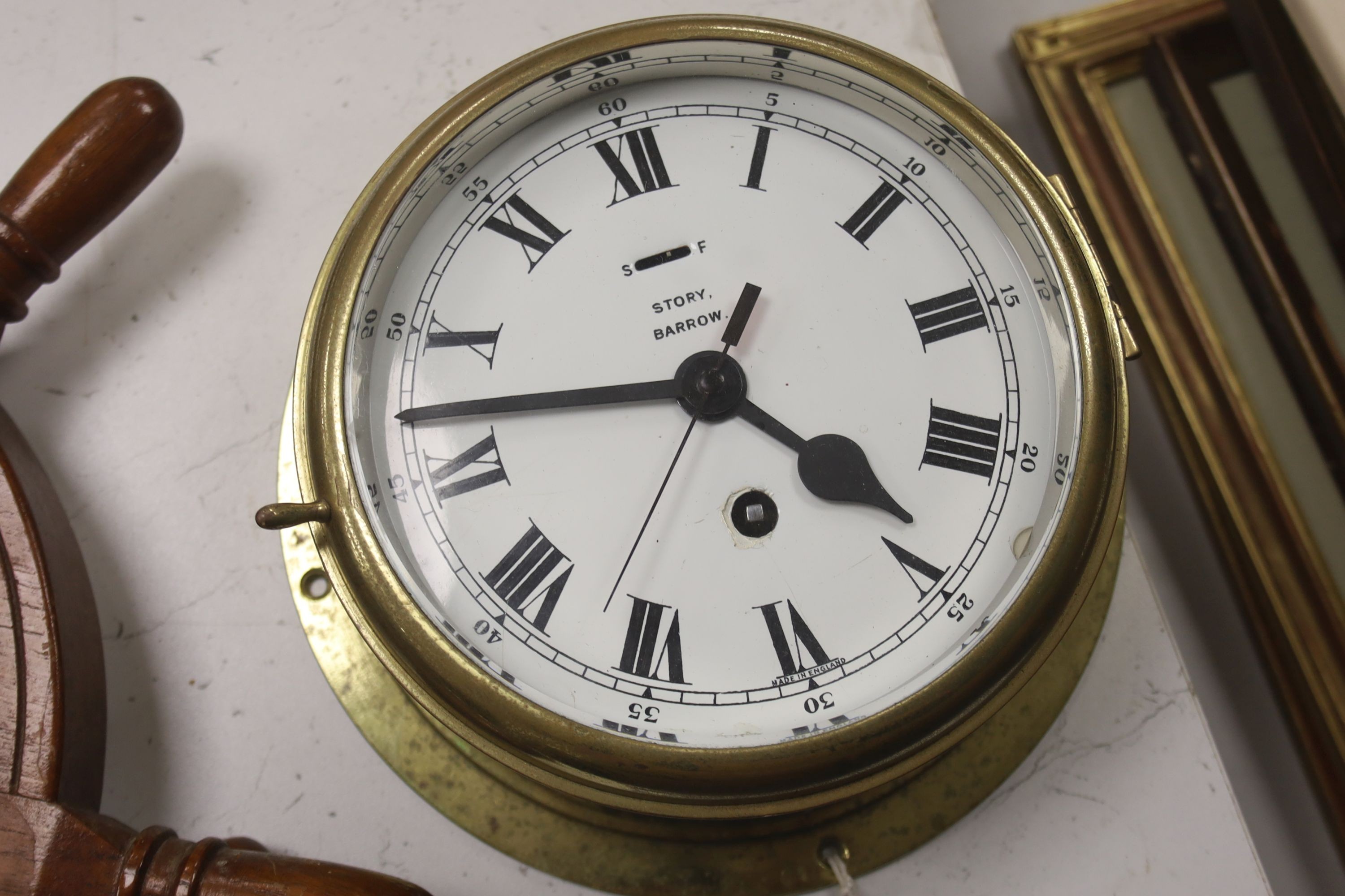 A brass bulkhead timepiece, enamelled dial signed Story, Barrow, dial 17cm, and a ship's wheel wall timepiece by Bayard